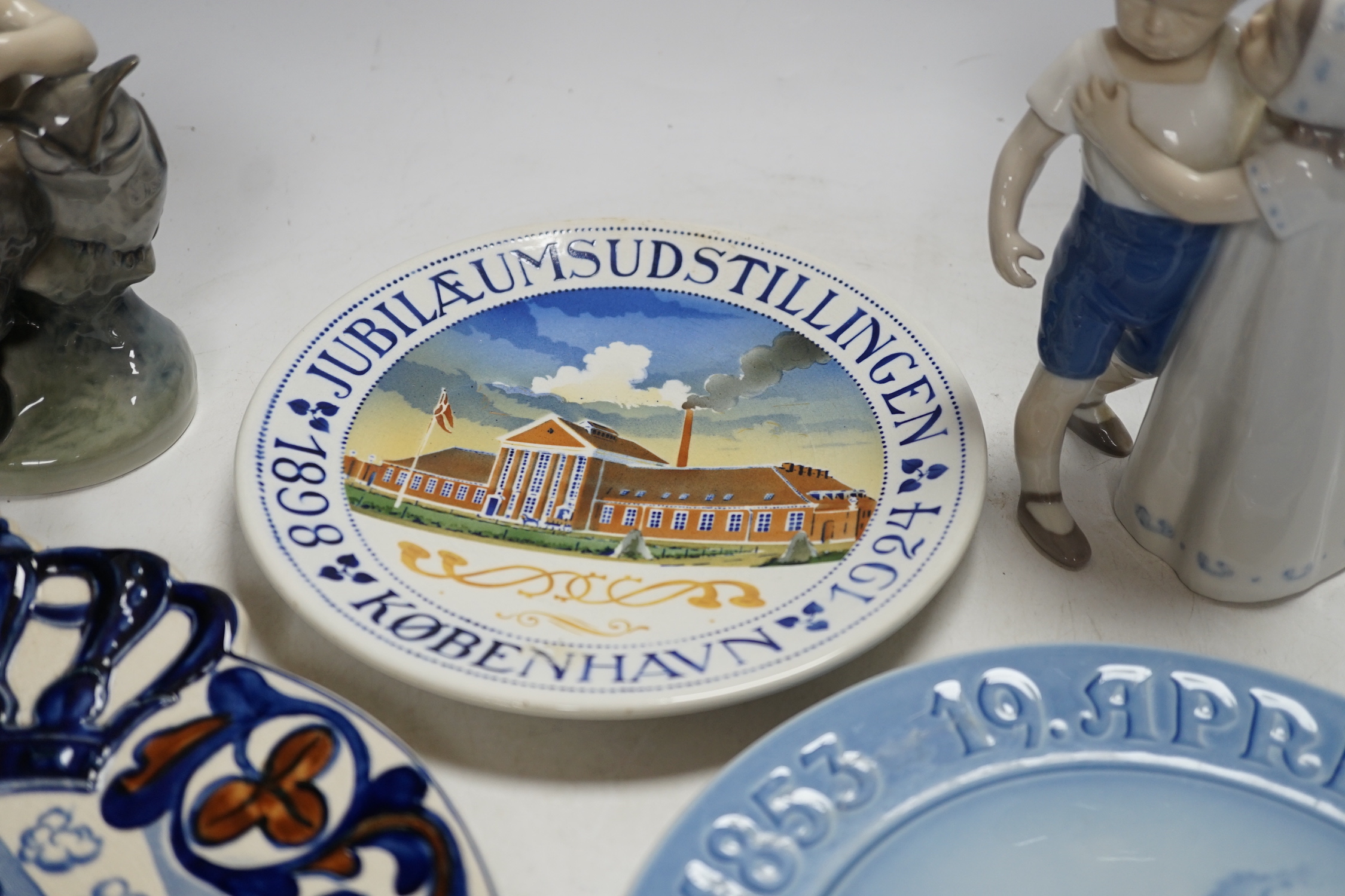 Three Royal Copenhagen and Bing and Grondahl commemorative plates and two figure groups, largest Carlsberg commemorative advertising plate 25.5cm high